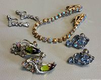 Full lot: sweater guard and three earring pairs