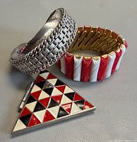 Group shot of Coro cuff bracelet, Guess triangular compact, red-white stretch bracelet