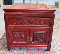 Front view showing carved drawer and double doors