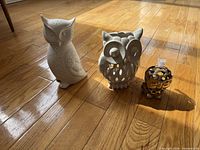 three owl items grouped on floor