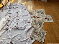 Overall shot of white embroidered tablecloth and four pillow covers