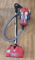 Full view of Dirt Devil canister vacuum with wand, hose and powered floor nozzle