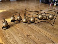 All three metal music-note candle holders displayed on floor
