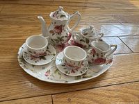 Complete miniature tea set arranged on platter