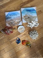 Overhead view showing coral pieces, canvases, tealight holder, one appetizer plate and suction fish