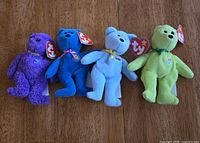 Front view of four Ty Teenie Beanie Bears showing colours, tags, ribbons and chest patches