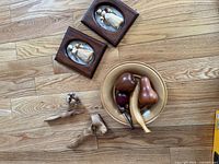 Group shot of all items: bowl with fruit, two framed dolls, two birds