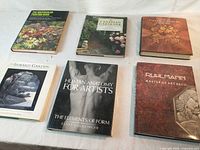 Six hardcover books laid out showing fronts