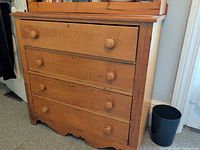 Front view of four-drawer pine dresser with hutch partially visible