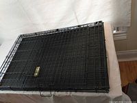 Crate folded flat on table, showing overall size when collapsed