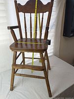 Full view of wood high chair on table