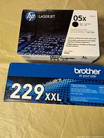 HP and Brother toner cartridge boxes side by side