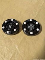 Both roller hockey pucks front view