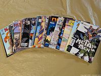 Front view of fanned stack of bagged comic books showing approximately 18 of the 30 issues