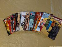 All 30 comics fanned out, showing variety of titles