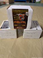 Three labeled card boxes; visible brands and years