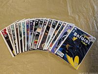 Seventeen bagged Batgirl comics fanned out showing full run and variant