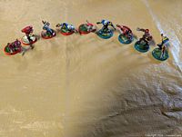 Row of ten Battle Ball miniatures on red and green bases