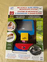 Front of sealed box showing microscope and accessories