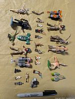 Overview of all Star Wars figures, vehicles and accessories laid out with marker for scale