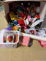 Overview of box showing mixed toys, track piece and basket