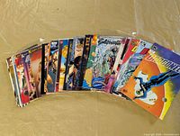 Top view of entire fan-shaped stack of 30 bagged comics