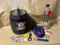 All items together: mini keg, Miller cap opener, matador figurine, Crown Royal bag, eight metal bottle openers