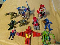Group shot of all action figures and jet on yellow surface