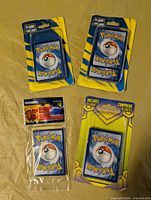 All four sealed Pokémon card packs displayed
