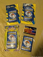 Group shot of four sealed Pokémon card packs