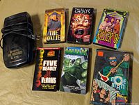 Overall lot showing VHS rewinder and six VHS tapes laid out