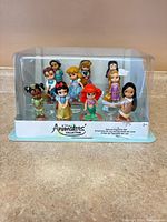 Ten figurines sealed in clear display case