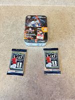 Front view of sealed Championship Collection tin with two sealed Donruss packs