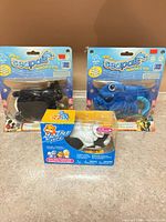 All three packaged toys: two Seapals cards, one Zhu Zhu Pets box