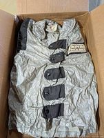 Jacket folded in box showing front button area and Empire Strikes Back patch