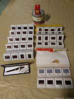 Overview of all slides, magazines, Kodak can and boxed pen