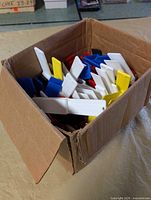 Box filled with assorted plastic clip markers