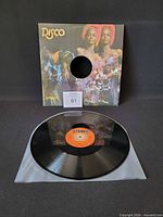 Front view of record sleeve and vinyl in poly sleeve