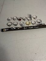 All 19 rings laid out, showing styles and metal tones