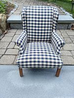 Front view of blue and cream plaid doll armchair showing upholstery and wood legs
