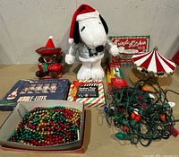 All items laid out including plush, lights, garland, tinsel, sign, carousel, game