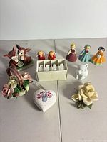 overview of entire lot showing all figurines, napkin rings, floral pieces