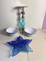 Group shot showing blue glass starfish bowl, teal glass & metal candle holder, two melamine starfish bowls