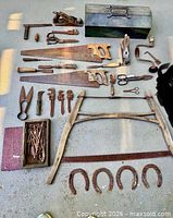 Full layout of all vintage tools, toolbox, buck saw frame, horse shoes and hardware