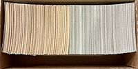 Two stacks of hockey trading cards in a cardboard box
