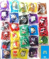 Front overview of 26 sealed Happy Meal items displayed