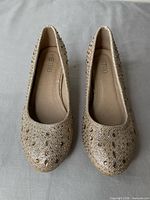 Top view of both shoes showing glitter and rhinestone decoration and insole branding