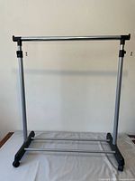 Front view showing full rack structure with casters, metal frame, black plastic base