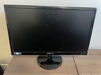 Front view of Hannspree 23-inch monitor powered off on stand