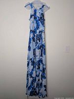 Full frontal view of the long blue floral dress on hanger